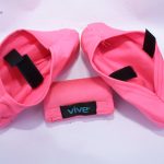 Vive® ankle and wrist weights in pink with black Velcro straps, featuring an accompanying storage pouch. Ideal for strength training and mobility workouts.