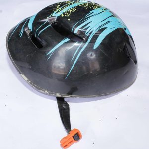 Black ventilated sports helmet with blue and yellow streaks, multiple airflow holes, and an orange buckle on the adjustable black strap, displayed on a white surface.