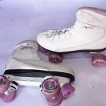 White Riedell roller skates with pink wheels, high-top laced boot, and durable bearings, displayed on a white surface.