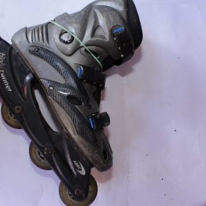 Black and gray Bladerunner ABEC 3 inline skate with blue accents, four-wheel frame, ankle support, and secure buckle fastening, displayed on a white surface.