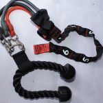 A set of three resistance bands (black, gray, red) with metal carabiners, black tricep rope handles, and a numbered multi-loop strap, displayed on a white surface.